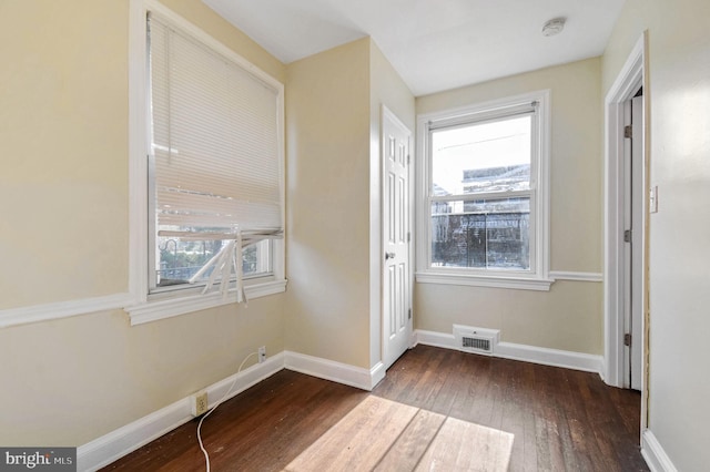 unfurnished bedroom with dark wood-type flooring