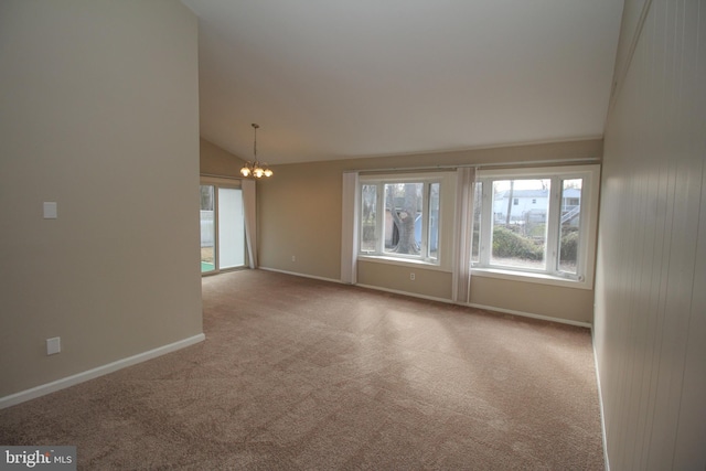 unfurnished room featuring light colored carpet, a chandelier, and lofted ceiling