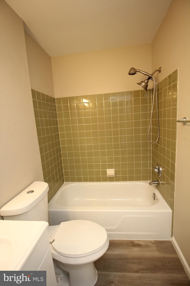 full bathroom featuring vanity, hardwood / wood-style flooring, toilet, and tiled shower / bath