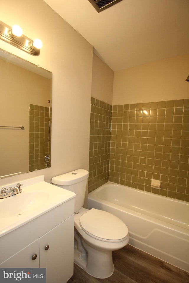 full bathroom featuring hardwood / wood-style flooring, vanity, toilet, and bathtub / shower combination