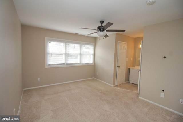 carpeted spare room with ceiling fan