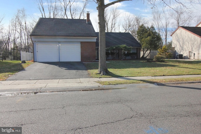 view of front of property with a front yard and a garage