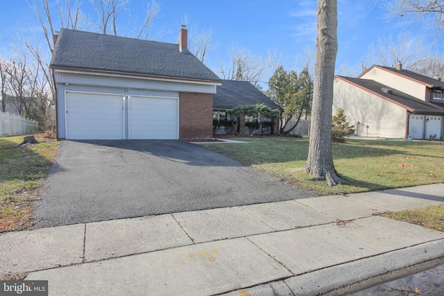 exterior space with a garage and a yard