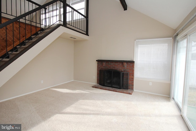 unfurnished living room featuring carpet flooring, plenty of natural light, and a fireplace