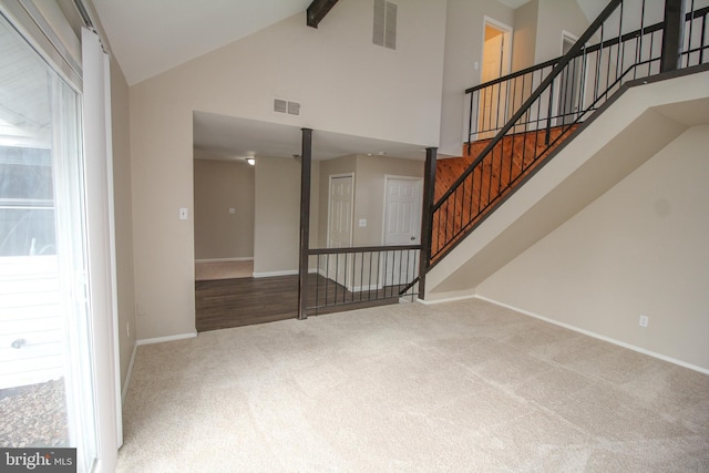 interior space with beam ceiling, carpet, and high vaulted ceiling