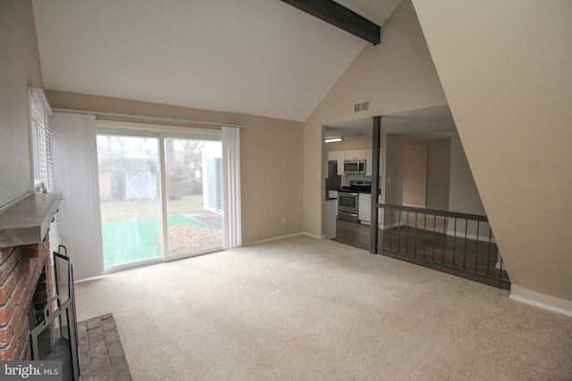 unfurnished living room featuring light carpet, a fireplace, beamed ceiling, and high vaulted ceiling