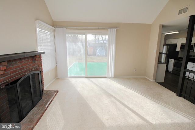 living room featuring light carpet, a brick fireplace, and lofted ceiling