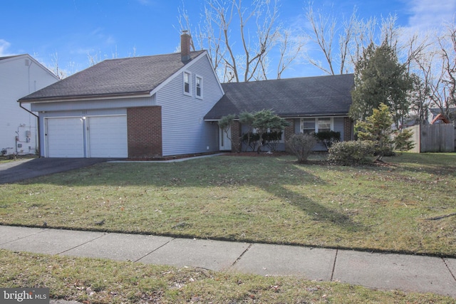 view of front of property with a front lawn and a garage