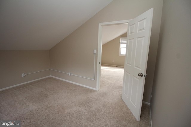 bonus room featuring light carpet and vaulted ceiling