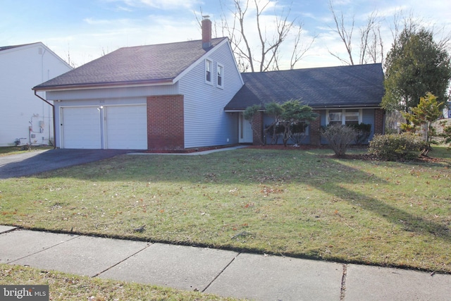 ranch-style home featuring a front yard and a garage