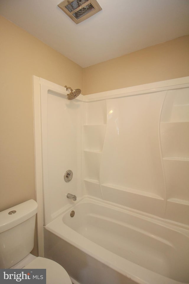 bathroom featuring shower / bath combination and toilet