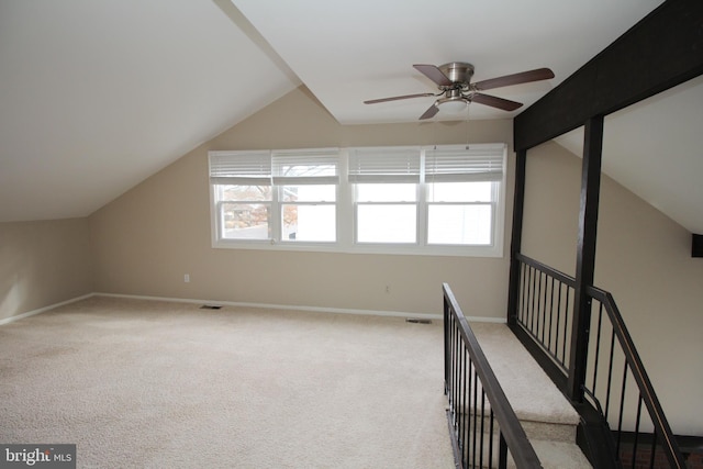 additional living space featuring ceiling fan, plenty of natural light, light carpet, and vaulted ceiling