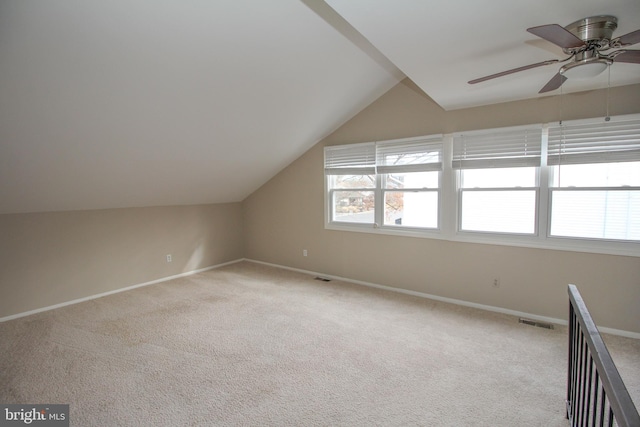 bonus room with ceiling fan, light colored carpet, and lofted ceiling