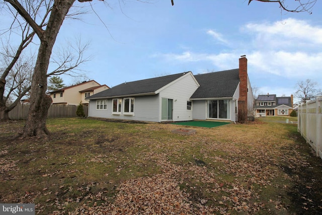 back of house with a lawn