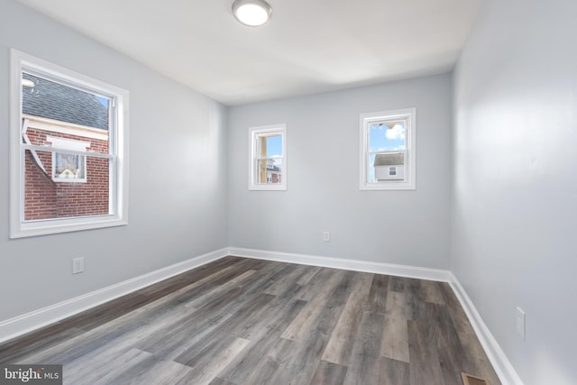 spare room with dark hardwood / wood-style floors