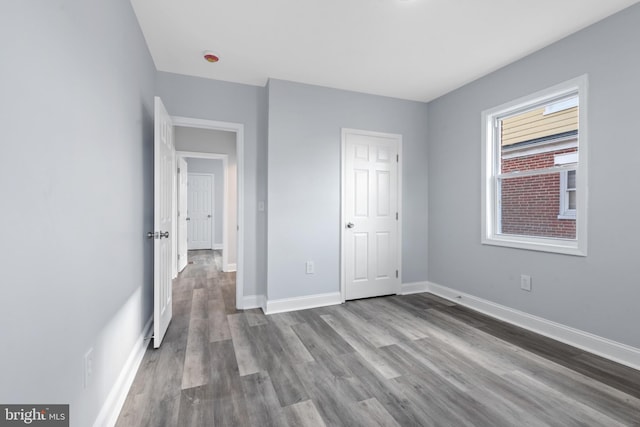 unfurnished bedroom featuring hardwood / wood-style flooring