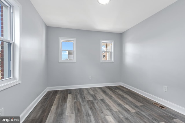 spare room with dark hardwood / wood-style floors