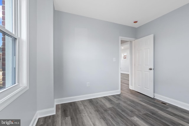 empty room featuring dark hardwood / wood-style flooring