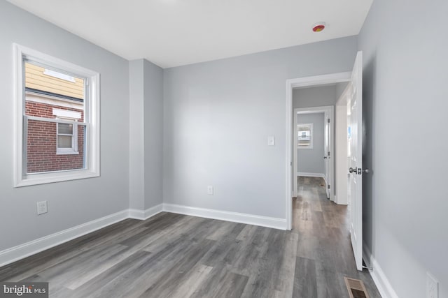 unfurnished room featuring dark hardwood / wood-style floors