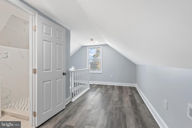 additional living space featuring lofted ceiling and wood-type flooring