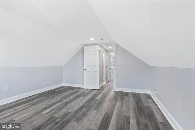 bonus room with lofted ceiling and dark hardwood / wood-style floors