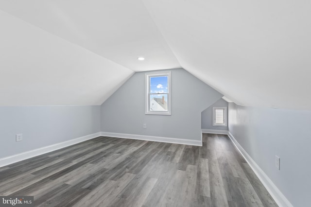 additional living space featuring lofted ceiling and dark hardwood / wood-style floors