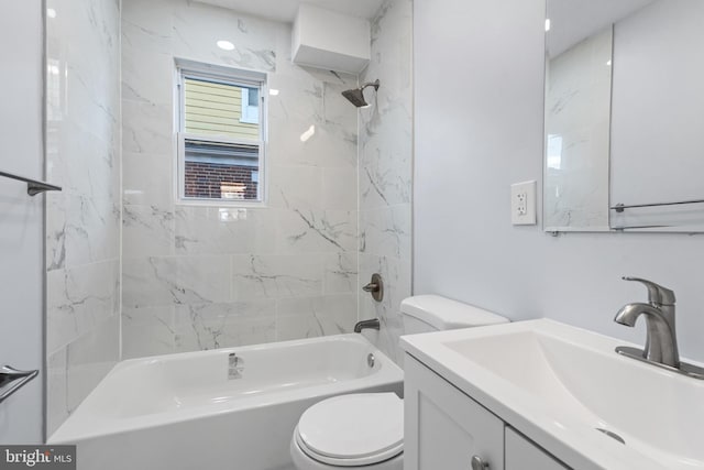 full bathroom featuring toilet, vanity, and tiled shower / bath combo