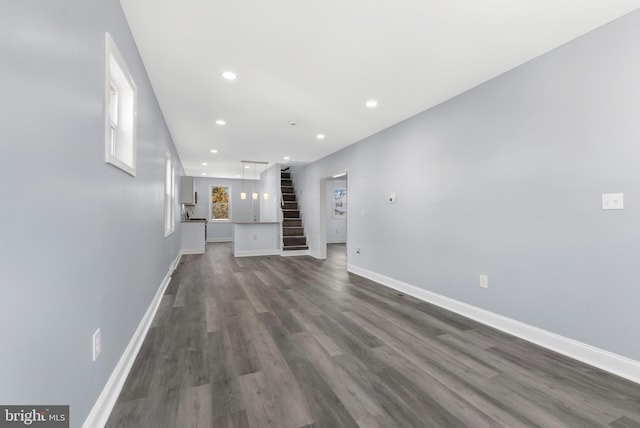 unfurnished living room featuring dark hardwood / wood-style flooring