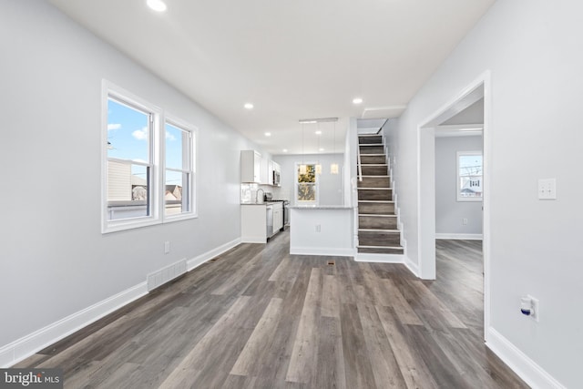 unfurnished living room featuring dark hardwood / wood-style floors