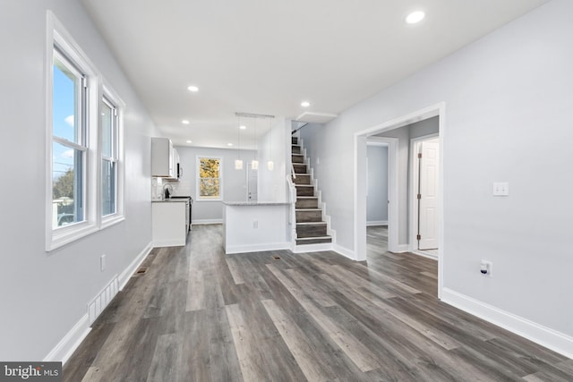 unfurnished living room with dark hardwood / wood-style floors