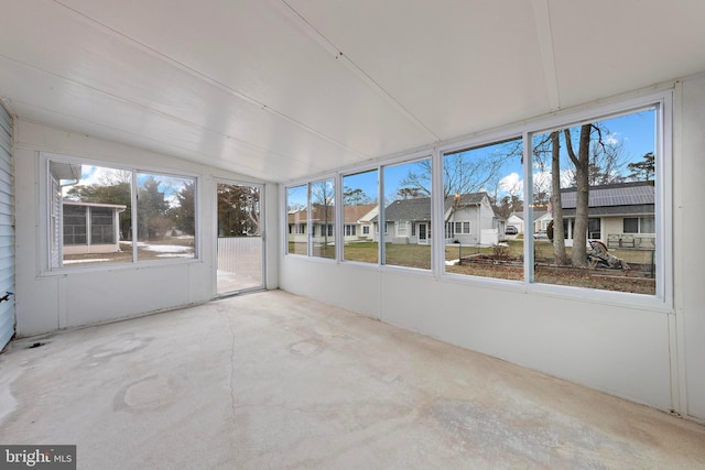 unfurnished sunroom with lofted ceiling