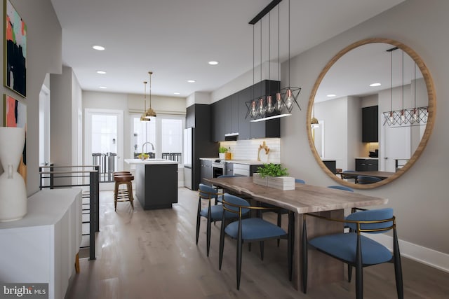 dining room with light hardwood / wood-style floors and sink