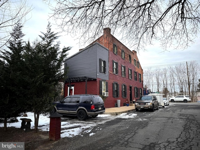 snow covered property with cooling unit