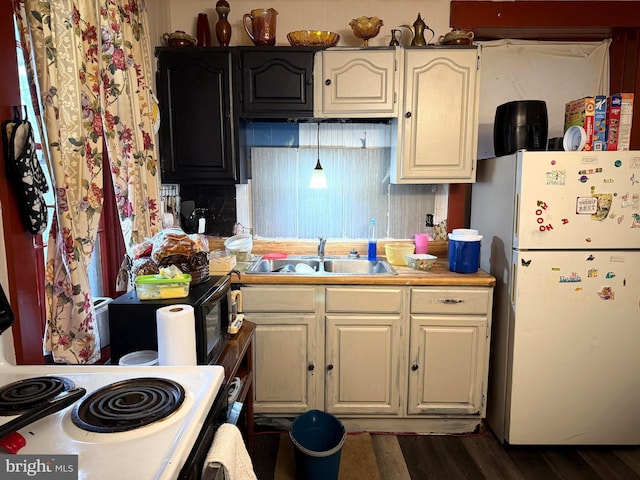 kitchen with white refrigerator, dark wood-type flooring, electric stove, and sink