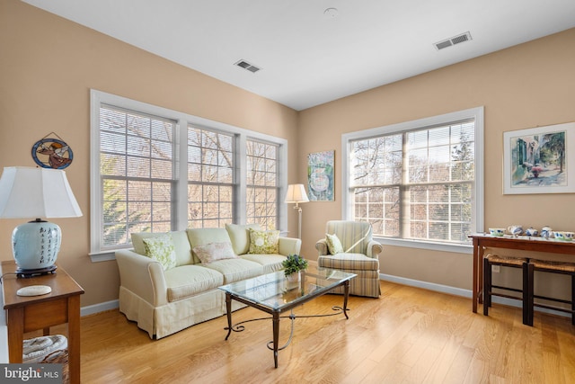 living area with a wealth of natural light and light wood-type flooring