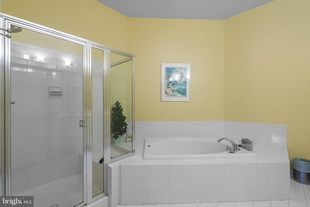 bathroom featuring separate shower and tub