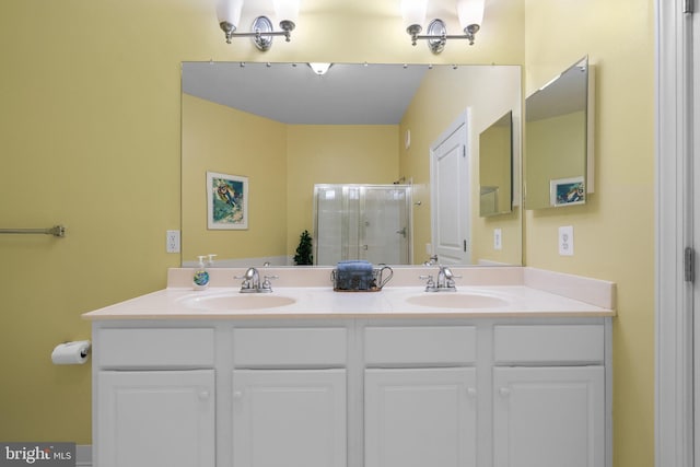 bathroom featuring walk in shower and vanity