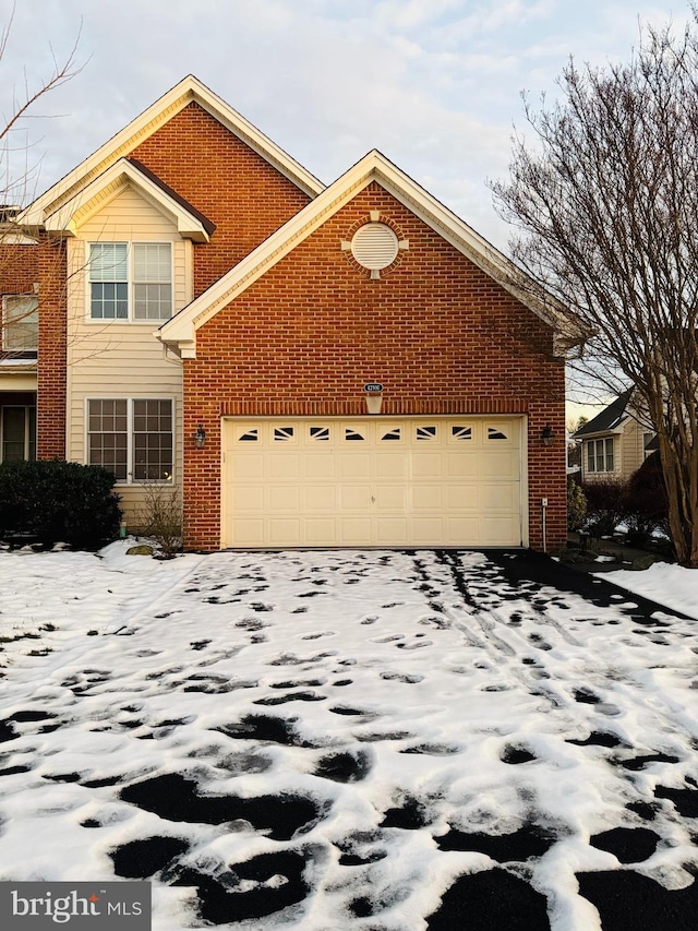 view of snowy exterior with a garage