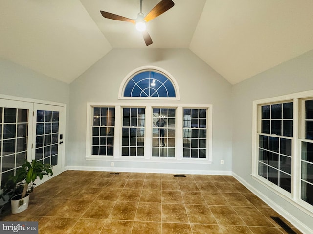 unfurnished sunroom featuring ceiling fan and lofted ceiling