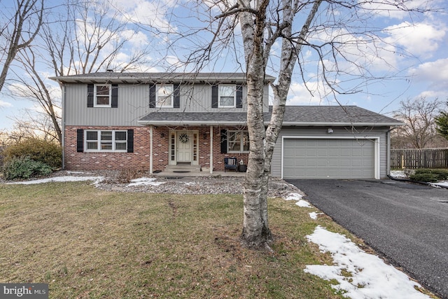 view of front property with a garage and a front yard