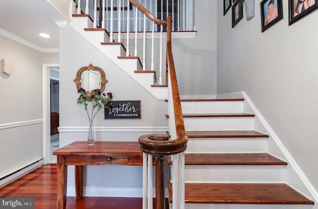 stairway featuring baseboard heating, hardwood / wood-style floors, and ornamental molding