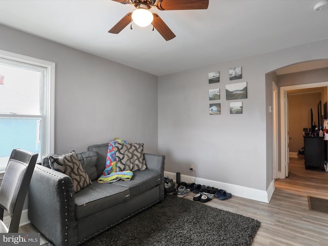 living room with ceiling fan and light hardwood / wood-style floors