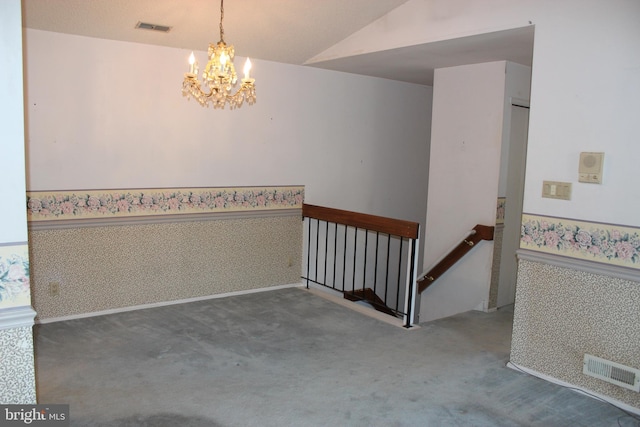 carpeted spare room with an inviting chandelier and lofted ceiling