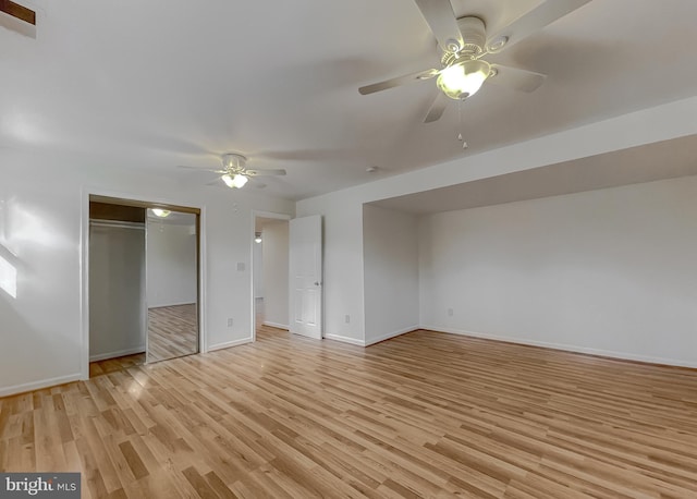 unfurnished bedroom with ceiling fan, light wood-type flooring, and a closet