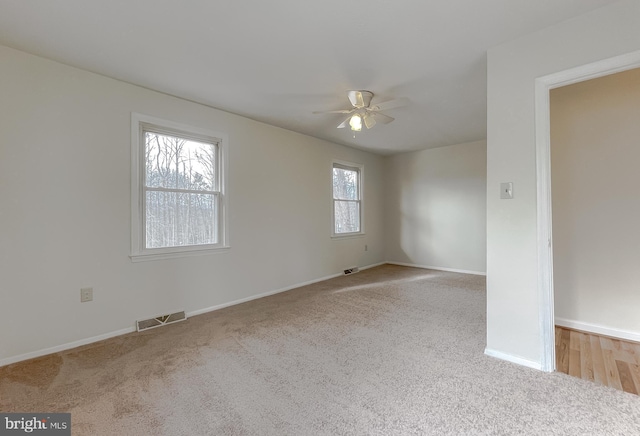 unfurnished room featuring ceiling fan and light colored carpet