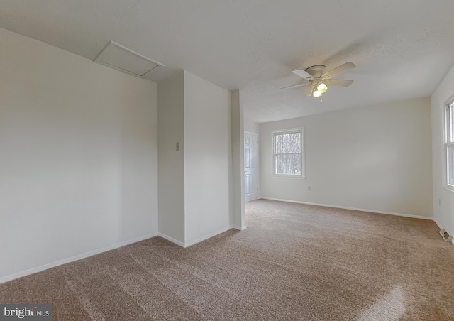 carpeted spare room with ceiling fan