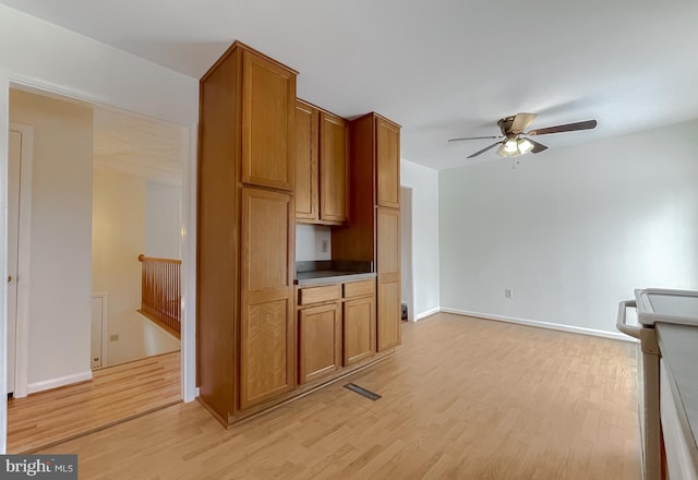 kitchen with ceiling fan and light hardwood / wood-style floors