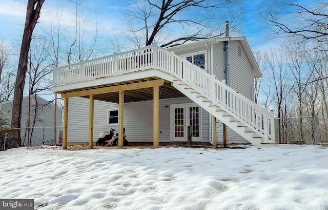 snow covered house featuring a deck