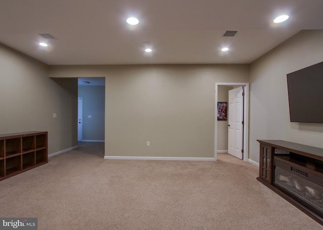 below grade area featuring baseboards, recessed lighting, visible vents, and light carpet