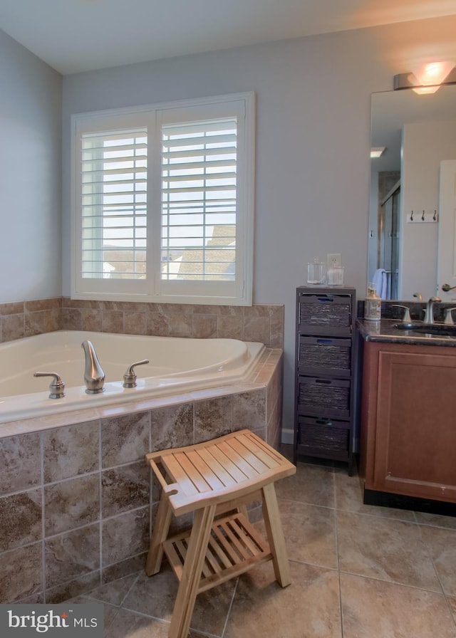 bathroom with a shower with shower door, a garden tub, vanity, and tile patterned flooring